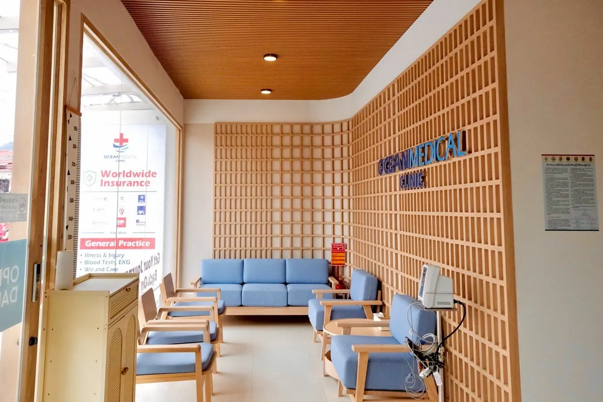 Waiting area at Ocean Medical Clinic Lamai with oak screens and blue seating