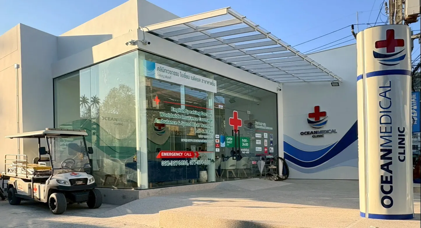 Glass-fronted Ocean Medical Clinic on Koh Phangan, with its covered entrance, clinic sign and medical transport cart